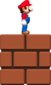 Mini Mario standing on top of a Brick Block.