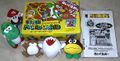 A Super Mario World themed Monty Mole plush alongside other plushies