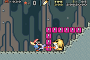 Super Mario World: Super Mario Advance 2 screenshot of Blue Yoshi eating a Mega Mole trapped between the red ! Blocks